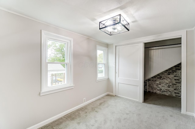 unfurnished bedroom featuring light carpet and a closet