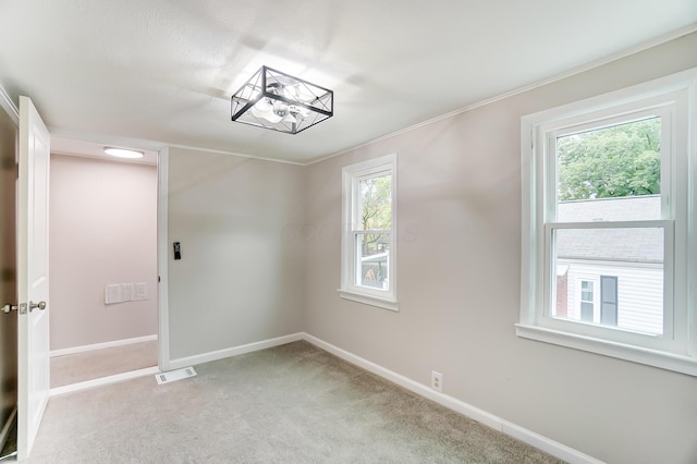 carpeted empty room with plenty of natural light