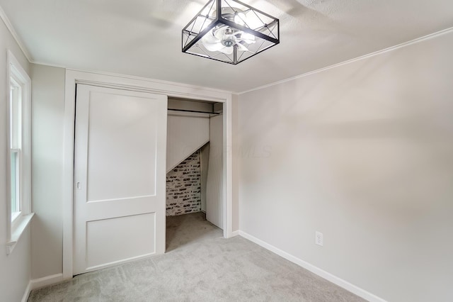 unfurnished bedroom with light colored carpet, a chandelier, and a closet