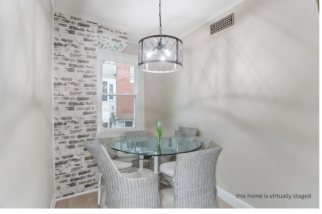 dining room featuring an inviting chandelier and hardwood / wood-style flooring