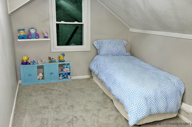 carpeted bedroom with lofted ceiling and a textured ceiling