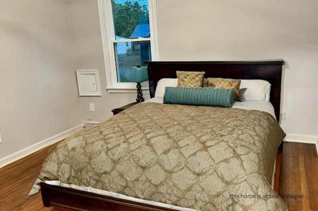 bedroom with hardwood / wood-style floors