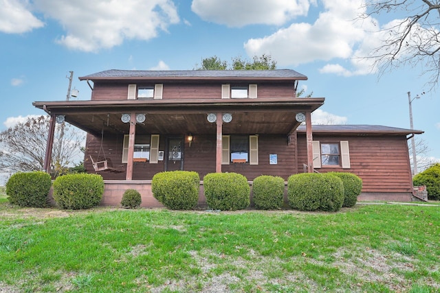 view of front facade featuring a front lawn and covered porch