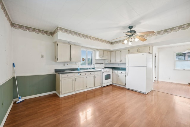 kitchen featuring ceiling fan, cream cabinetry, white appliances, and light wood-type flooring