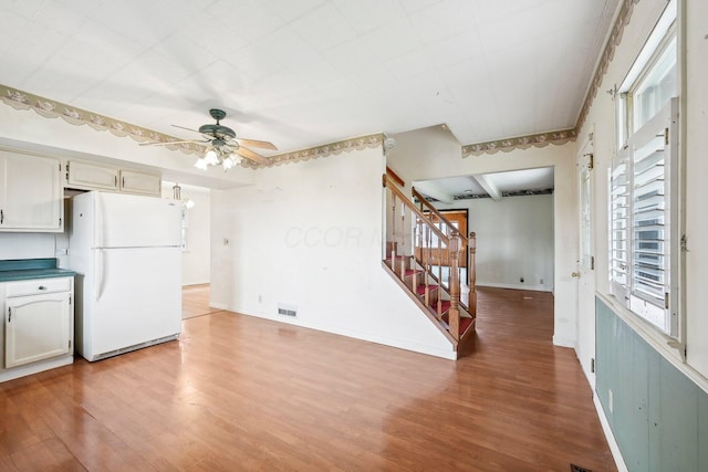 kitchen with white refrigerator, hardwood / wood-style flooring, and ceiling fan