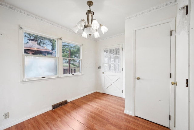 interior space featuring an inviting chandelier and light wood-type flooring