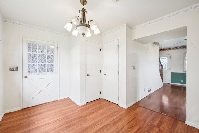 interior space with an inviting chandelier and light hardwood / wood-style flooring