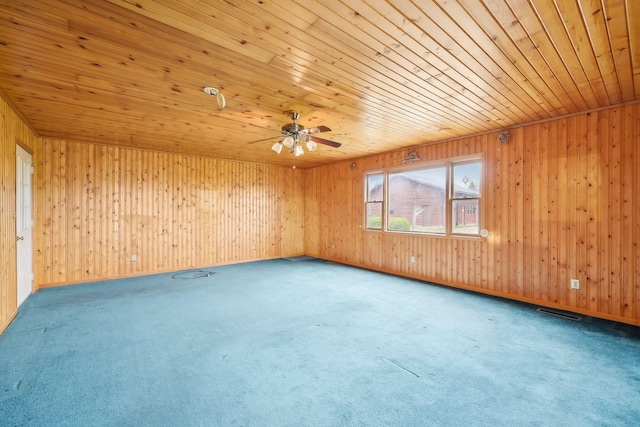 unfurnished room with wooden ceiling, carpet floors, and wooden walls