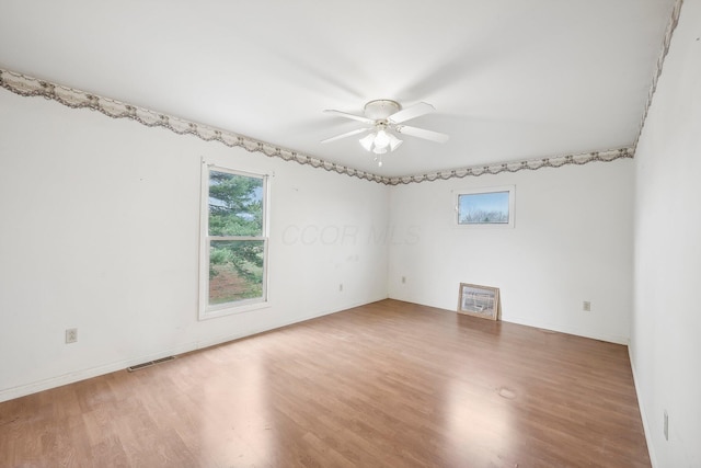 empty room with ceiling fan and wood-type flooring