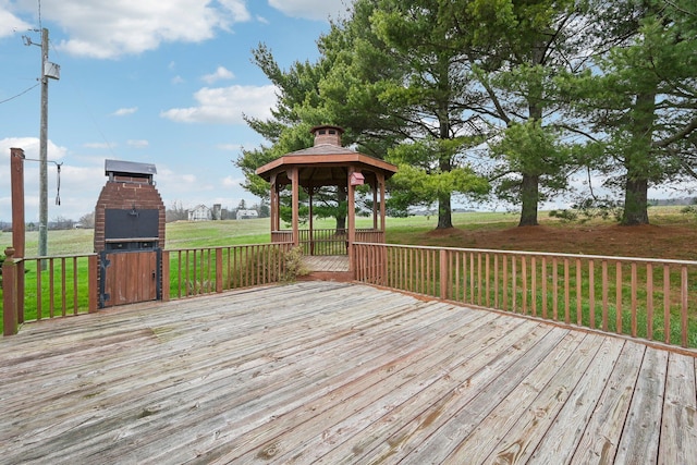 wooden deck featuring a gazebo and a lawn