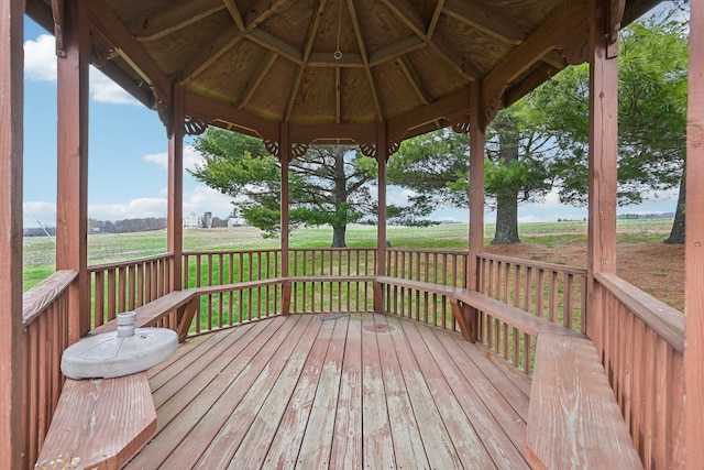 wooden terrace with a gazebo and a yard