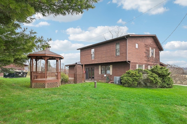 back of house with a gazebo, cooling unit, and a yard