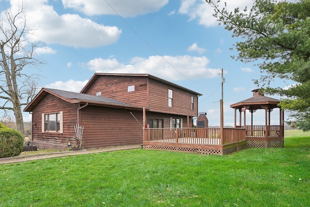 rear view of property featuring a gazebo, a yard, and a wooden deck