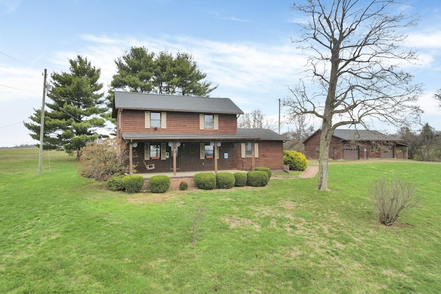 rear view of property featuring a lawn and a porch