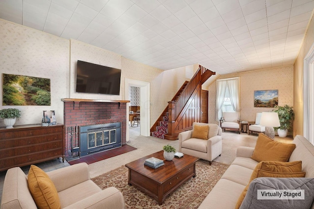 carpeted living area with wallpapered walls, stairs, and a fireplace