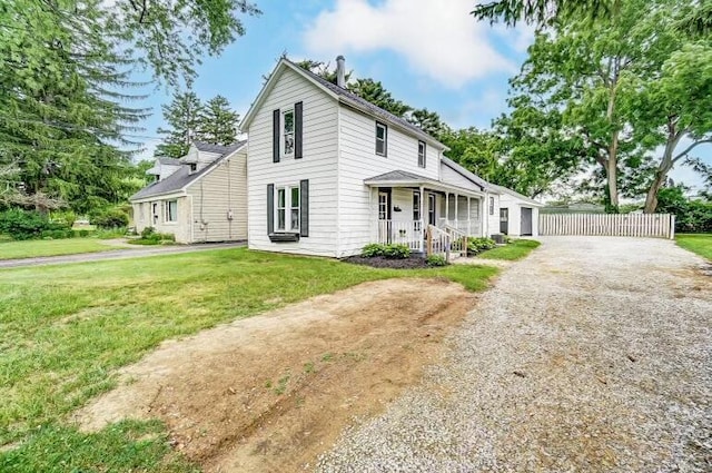 view of front of house with covered porch and a front yard