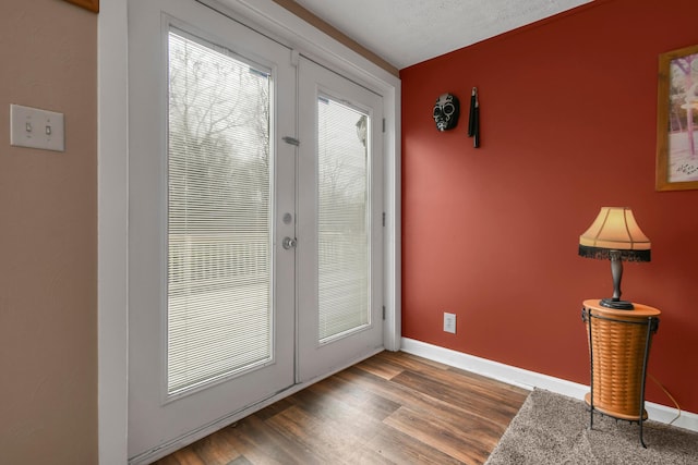 entryway with french doors, a textured ceiling, and hardwood / wood-style flooring