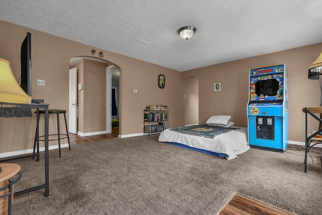 carpeted bedroom featuring a textured ceiling