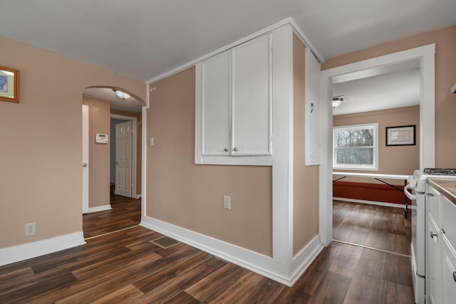 hallway with dark wood-type flooring