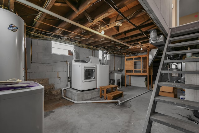 basement featuring washer and dryer, sink, and water heater