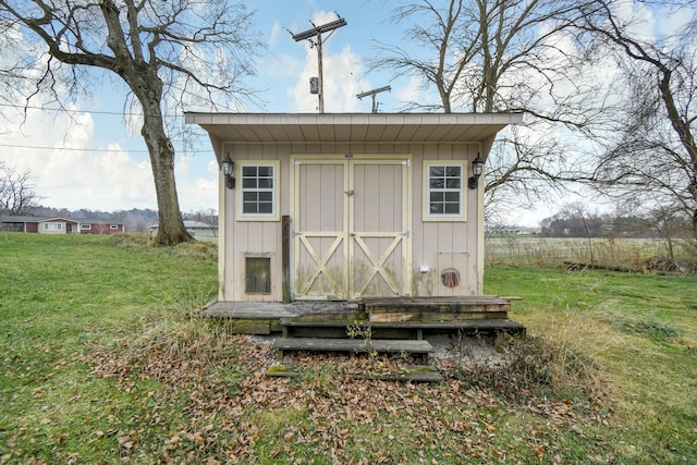 view of outbuilding with a lawn