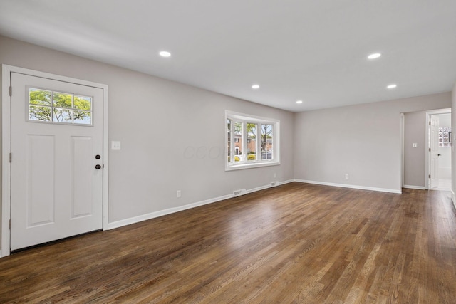 entrance foyer with a wealth of natural light and dark wood-type flooring