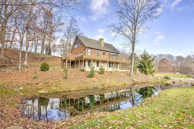 back of house featuring a water view