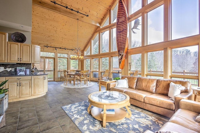 living room featuring an inviting chandelier, high vaulted ceiling, plenty of natural light, and wood ceiling