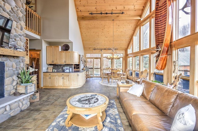 living room featuring high vaulted ceiling, wood ceiling, and an inviting chandelier