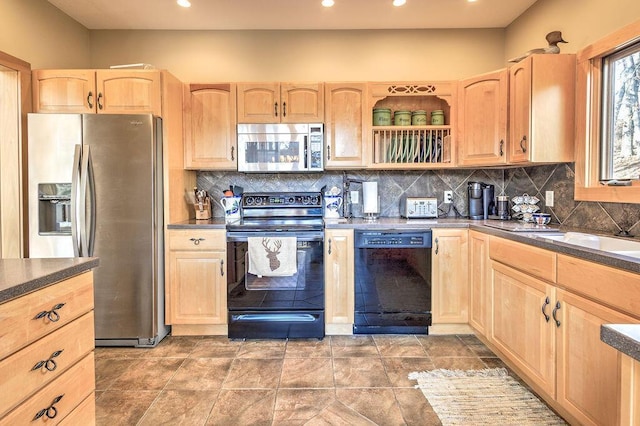 kitchen with tasteful backsplash, light brown cabinetry, and black appliances