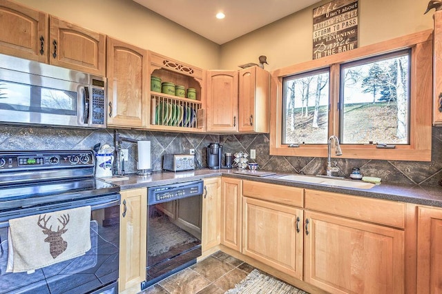 kitchen featuring black appliances, backsplash, and sink