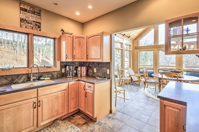 kitchen with backsplash, sink, and high vaulted ceiling