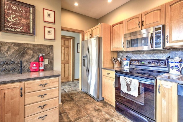 kitchen with appliances with stainless steel finishes, tasteful backsplash, and light brown cabinetry