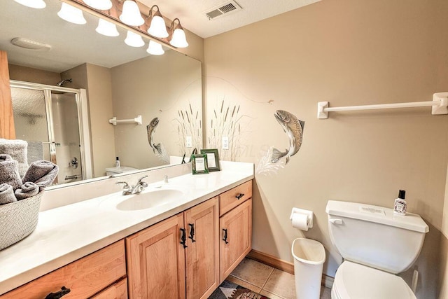 bathroom featuring tile patterned floors, vanity, toilet, and an enclosed shower