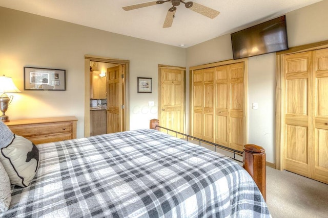 carpeted bedroom with ceiling fan and a closet