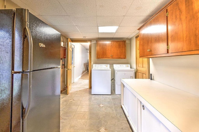 laundry room featuring light tile patterned flooring and separate washer and dryer