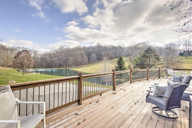 wooden deck featuring a yard and a water view