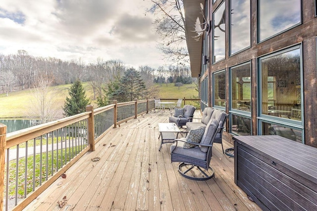 deck featuring an outdoor living space and a water view