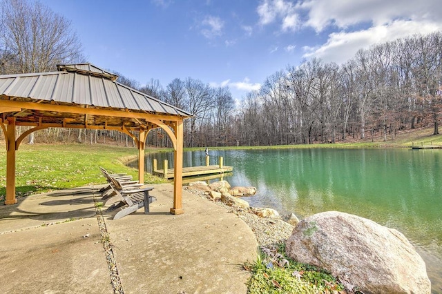 dock area featuring a gazebo, a yard, and a water view