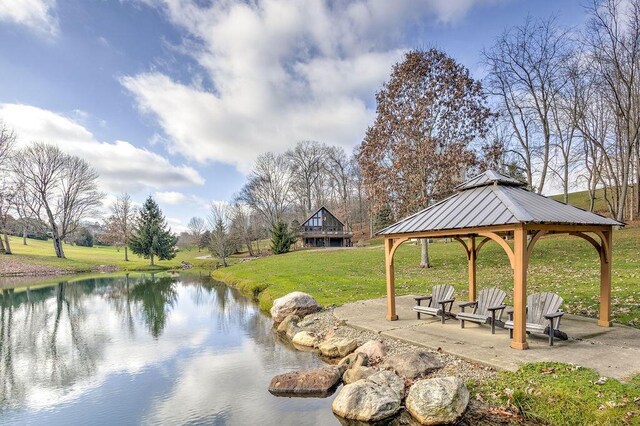 exterior space with a gazebo, a yard, and a water view