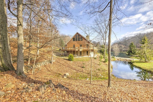 exterior space featuring a deck with water view