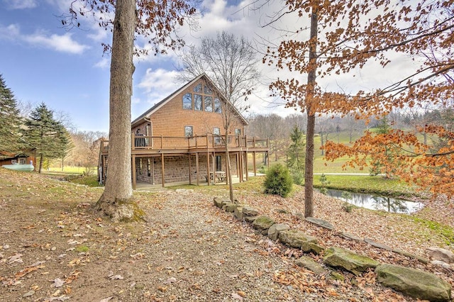 rear view of house featuring a wooden deck