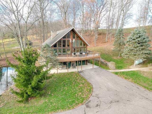 view of front of property with a front yard and a wooden deck