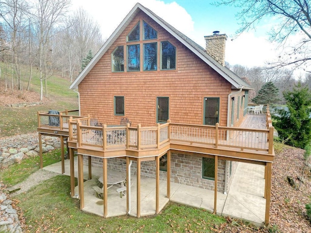 rear view of house with a deck and a patio area