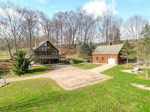 view of yard with a garage, an outdoor structure, and a wooden deck