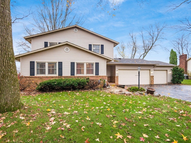 view of front property with a front yard and a garage