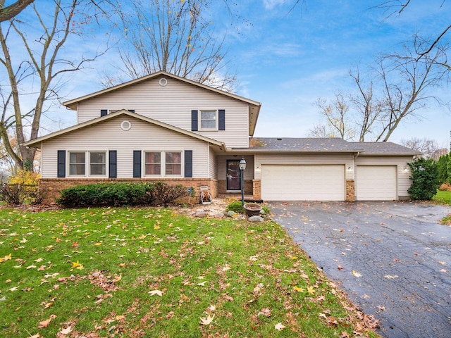 view of front property featuring a garage and a front lawn