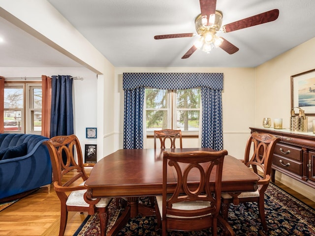 dining room with ceiling fan, plenty of natural light, and light wood-type flooring