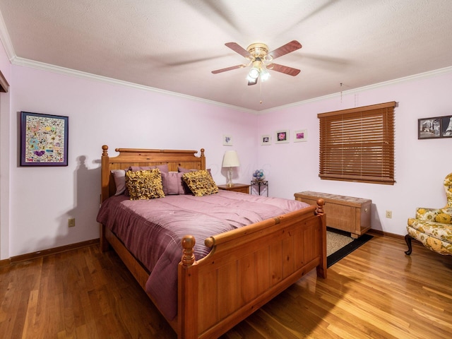 bedroom with ceiling fan, ornamental molding, a textured ceiling, and light wood-type flooring