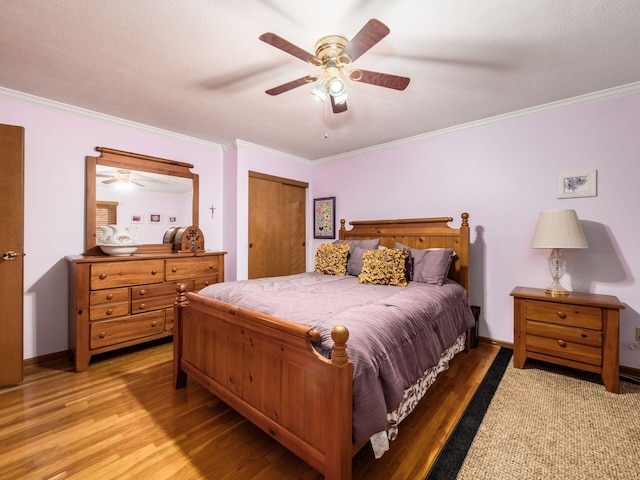 bedroom featuring ceiling fan, ornamental molding, and hardwood / wood-style flooring